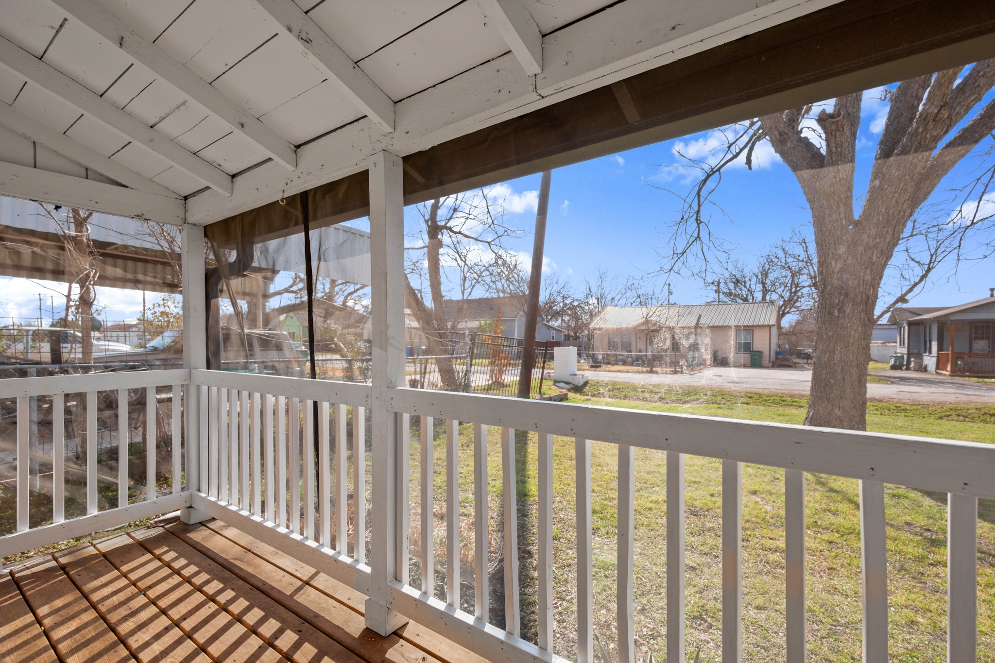 918 West 3rd Street Taylor, TX 76574 - Photo 4 of 22 Unfurnished sunroom with a residential view and lofted ceiling with beams