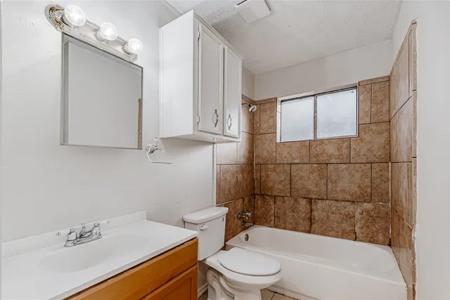 a bathroom with a sink mirror toilet and bathtub