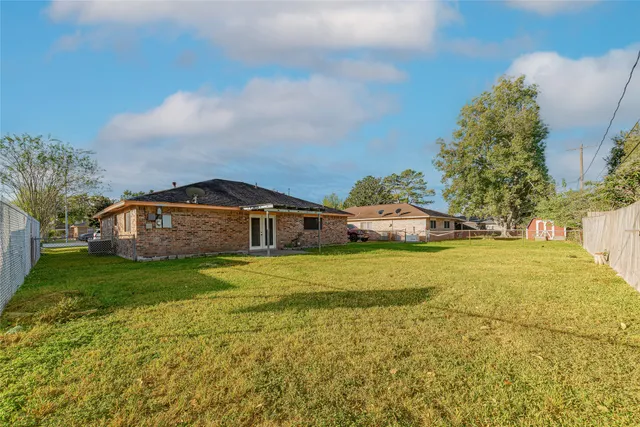 a front view of a house with a yard and trees