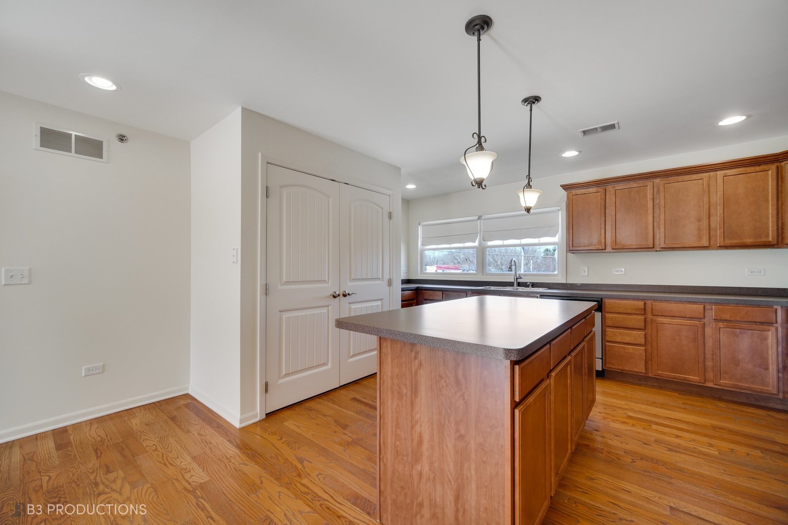 19235 Wolf Road, Unit 200 Mokena, IL 60448 - Photo 9 of 18 a kitchen with stainless steel appliances granite countertop a sink a stove and a wooden floors