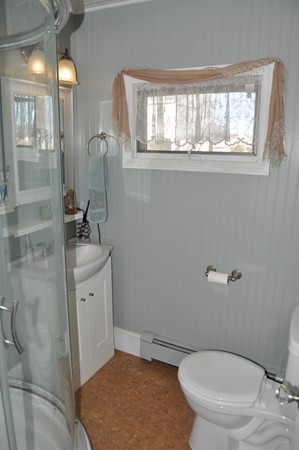 193 Swifts Beach Road Wareham, MA 02571 - Photo 10 of 24 a white toilet sitting next to a bathroom sink