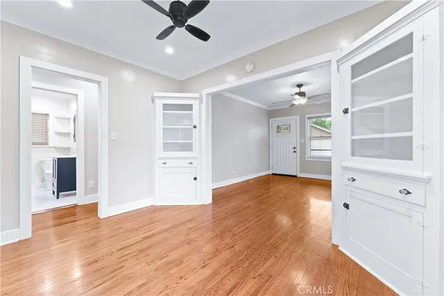 a view of empty room with wooden floor and cabinet
