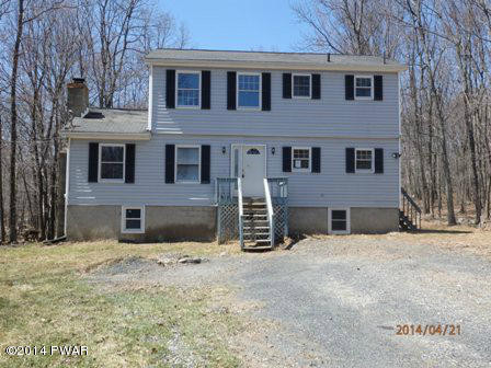 138 Laurel Court Bushkill, PA 18324 - Photo 1 of 1 a view of a house with a yard covered in snow