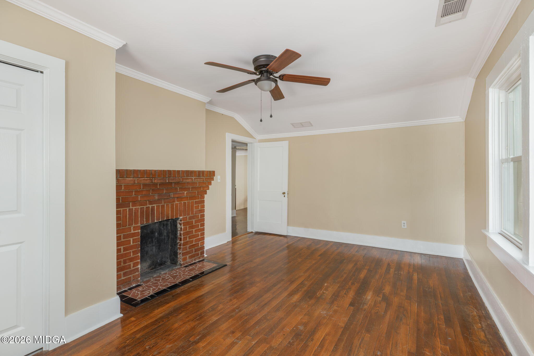 107 Childs Street Gray, GA 31032 - Photo 31 of 37 a view of a livingroom with a ceiling fan wooden floor and a window