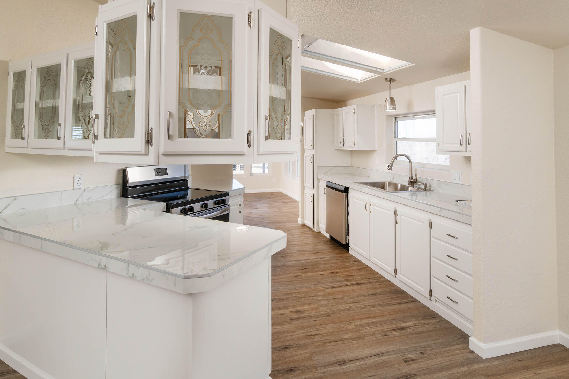 10113 Ridgeview Road Prineville, OR 97754 - Photo 6 of 31 a kitchen with stainless steel appliances granite countertop a sink and cabinets with wooden floor