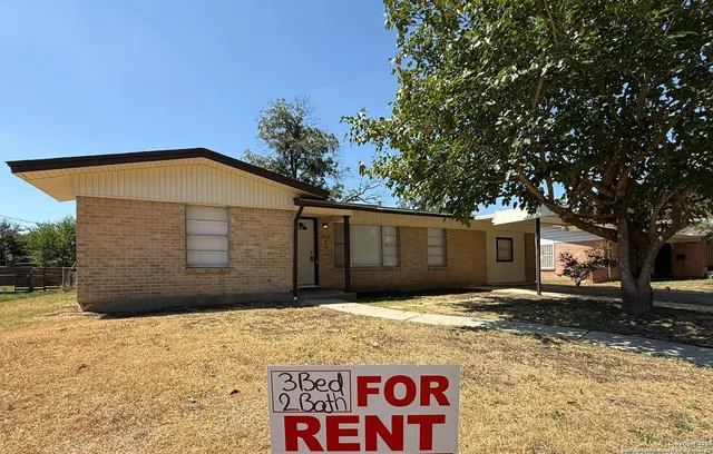 a blue sign that is sitting in front of a house