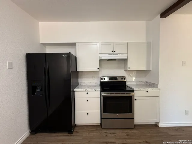 a kitchen with a stove and a refrigerator