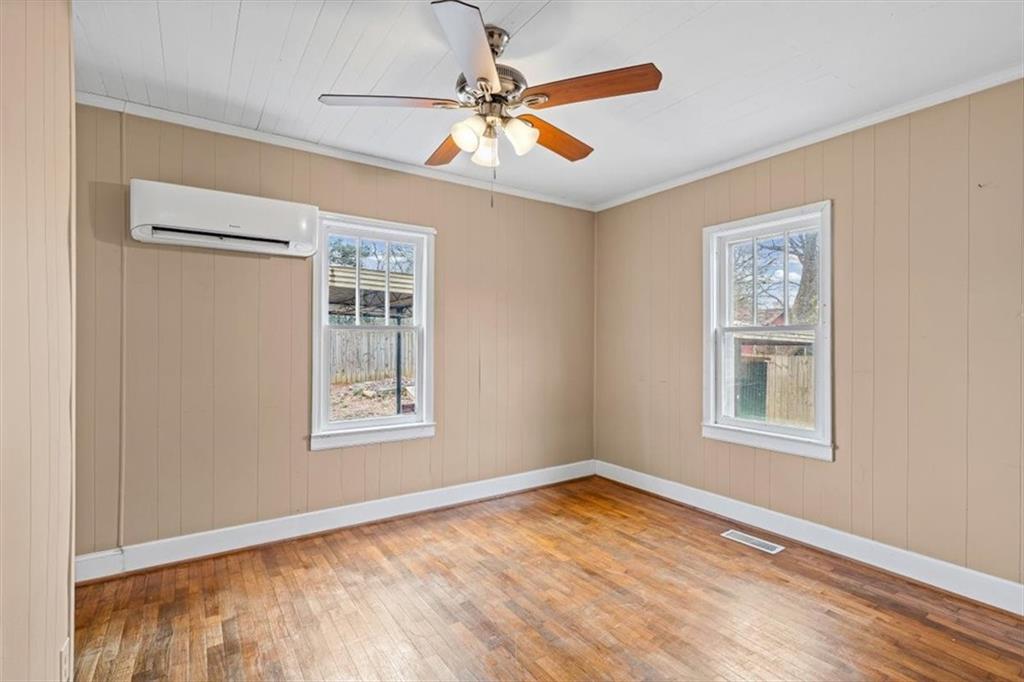 202 Gordon Street Rockmart, GA 30153 - Photo 16 of 25 a view of an empty room with window and wooden floor