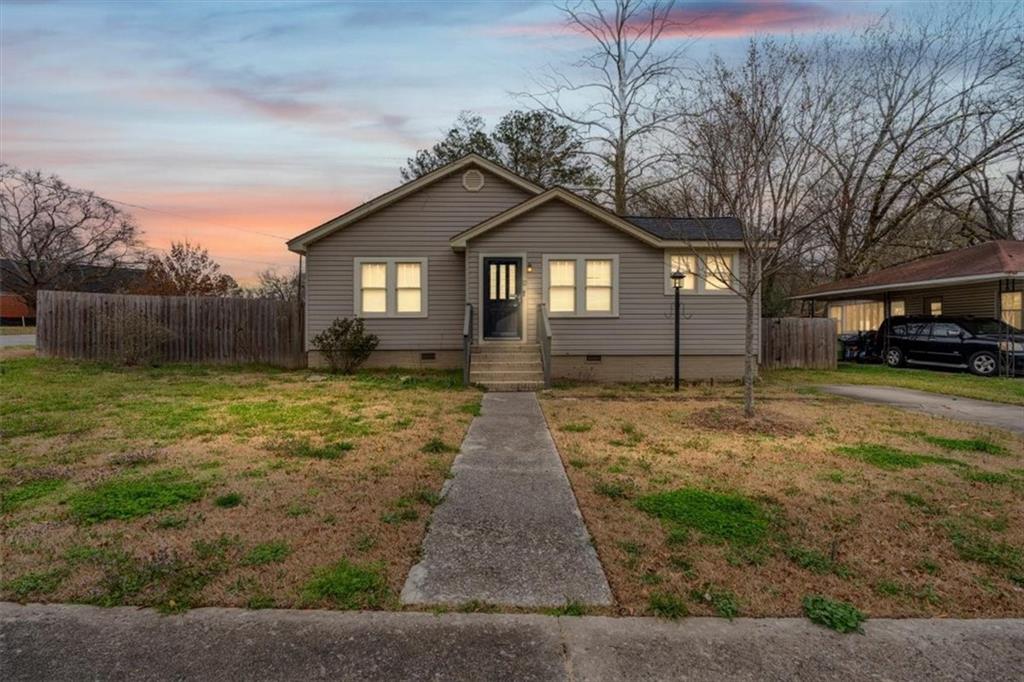 202 Gordon Street Rockmart, GA 30153 - Photo 2 of 25 a front view of a house with a yard and garage