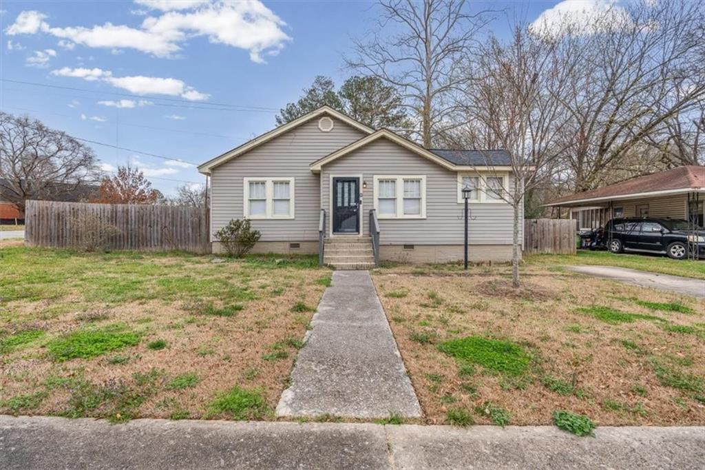 202 Gordon Street Rockmart, GA 30153 - Photo 3 of 25 a front view of a house with a yard and garage