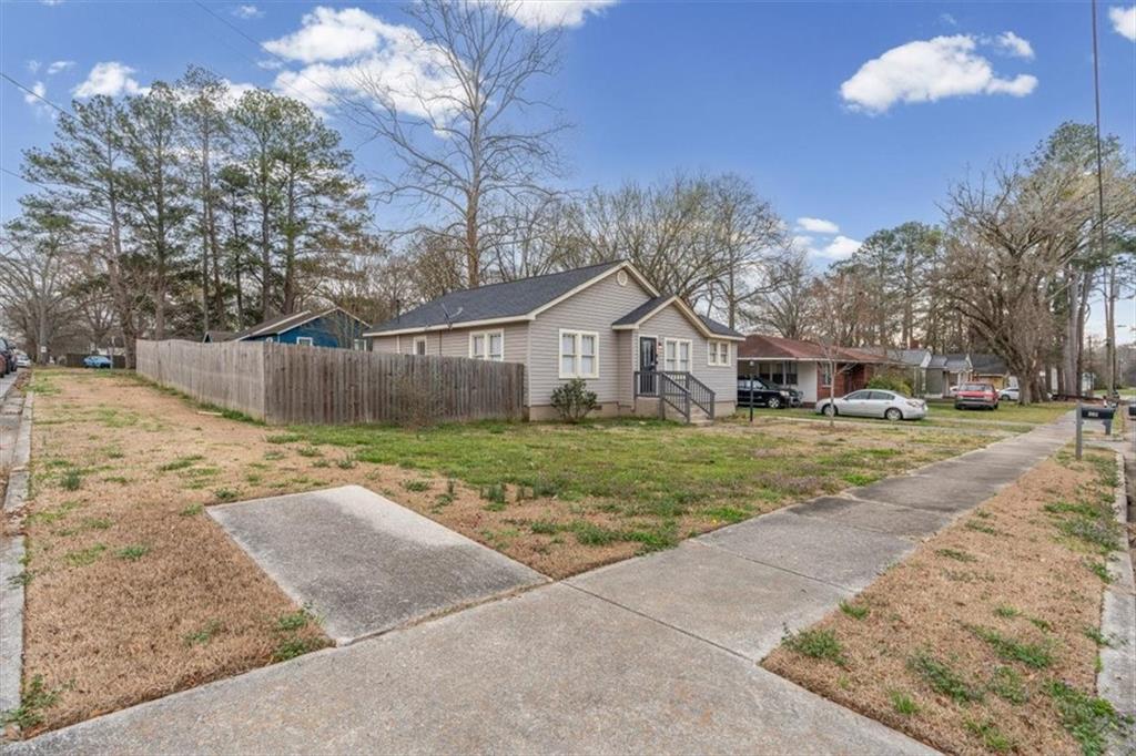 202 Gordon Street Rockmart, GA 30153 - Photo 4 of 25 a front view of a house with a yard and garage