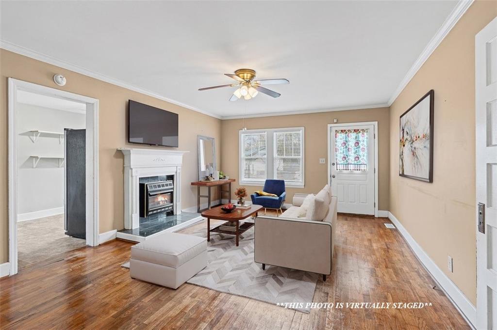 202 Gordon Street Rockmart, GA 30153 - Photo 9 of 25 a living room with furniture fireplace and a flat screen tv