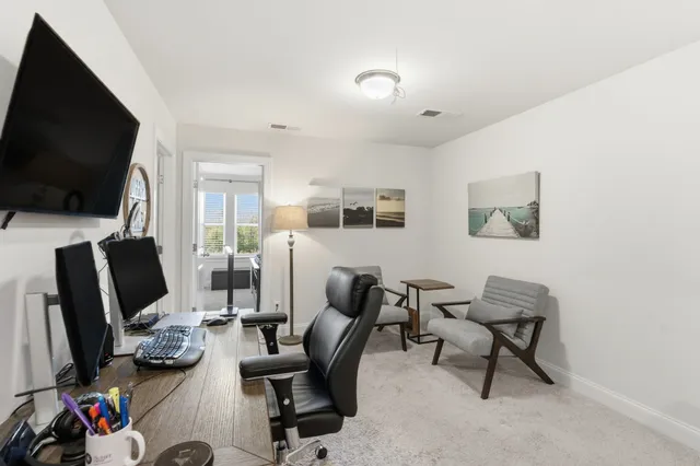a view of a livingroom with workspace and a couch