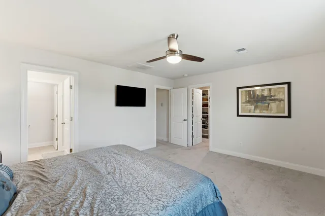 a bedroom with a large bed and a flat screen tv