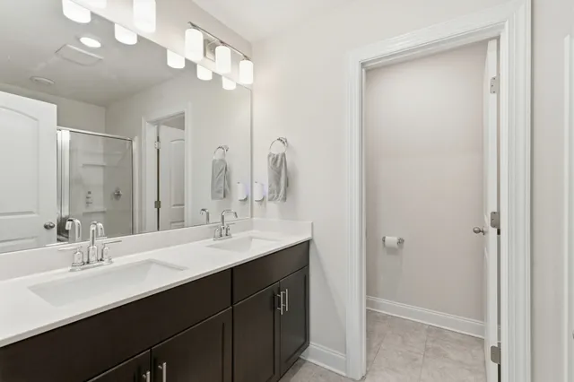 a bathroom with a double vanity sink and a mirror