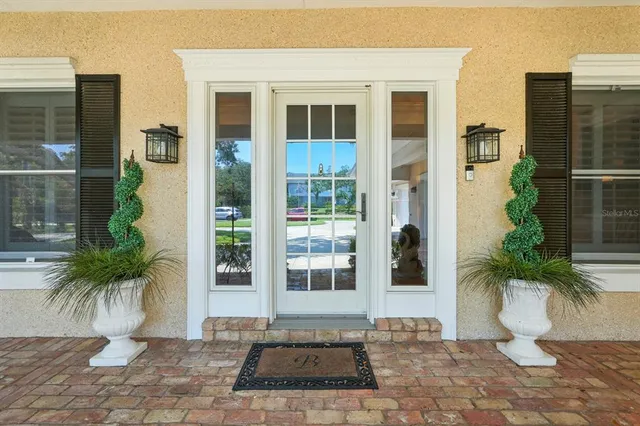 a view of a kitchen with stainless steel appliances a sink and cabinets