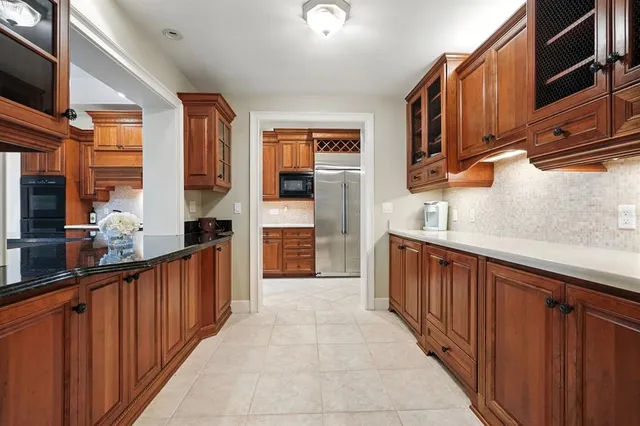 a view of empty room with wooden floor and chandelier