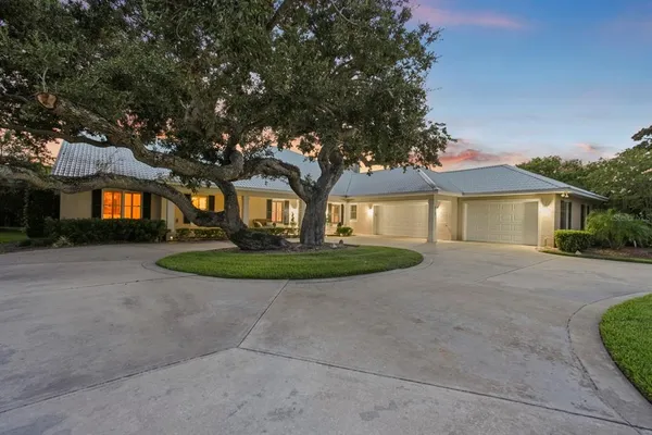 an aerial view of a house with outdoor space lake view and boat