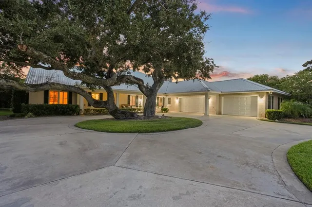 an aerial view of a house with outdoor space lake view and boat