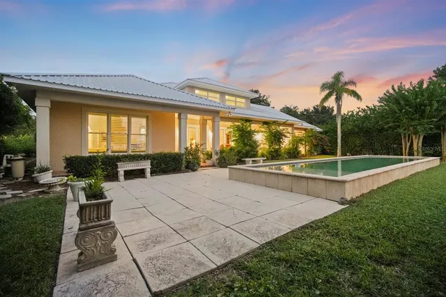 a front view of a house with a yard and potted plants