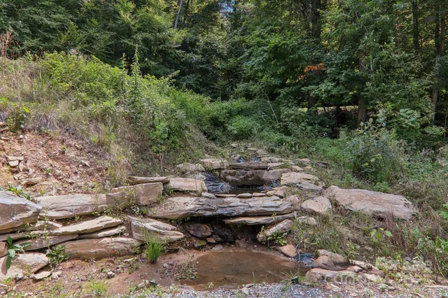 a backyard of a house with yard and outdoor seating