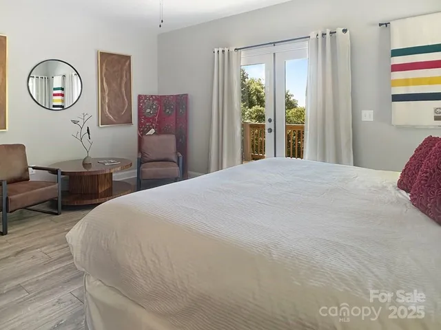 a bedroom with a bed mirror and a window