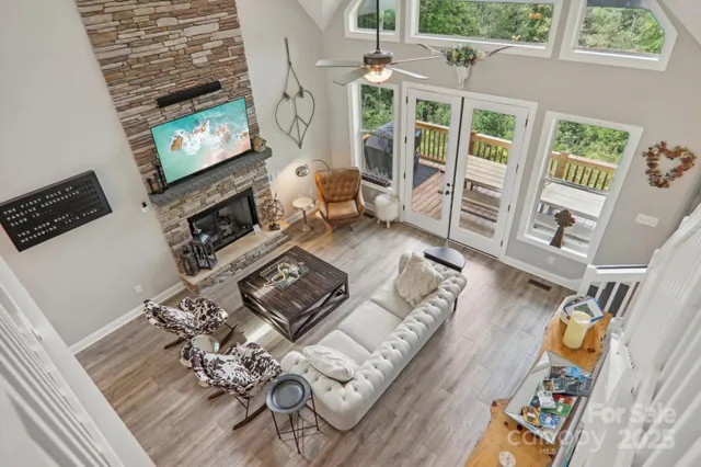 a living room with furniture a fireplace and a flat screen tv