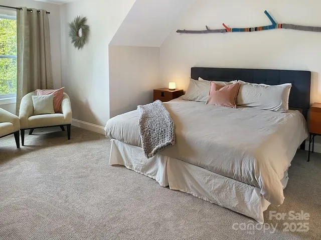 a bedroom with a bed and a couch