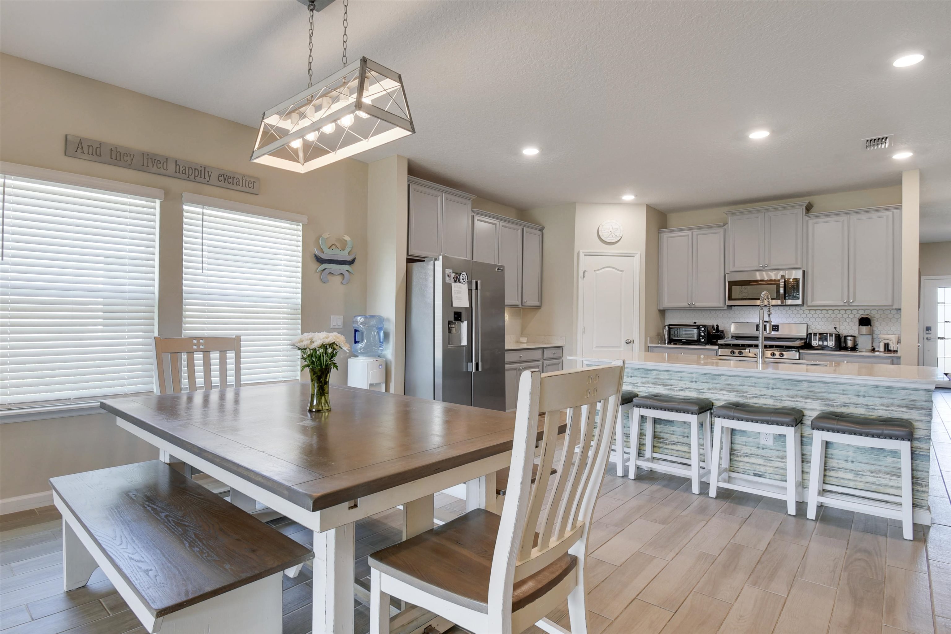 53 Cloverly Point St. Augustine, FL 32092 - Photo 14 of 51 a kitchen with kitchen island granite countertop a center island a sink cabinets and wooden floor