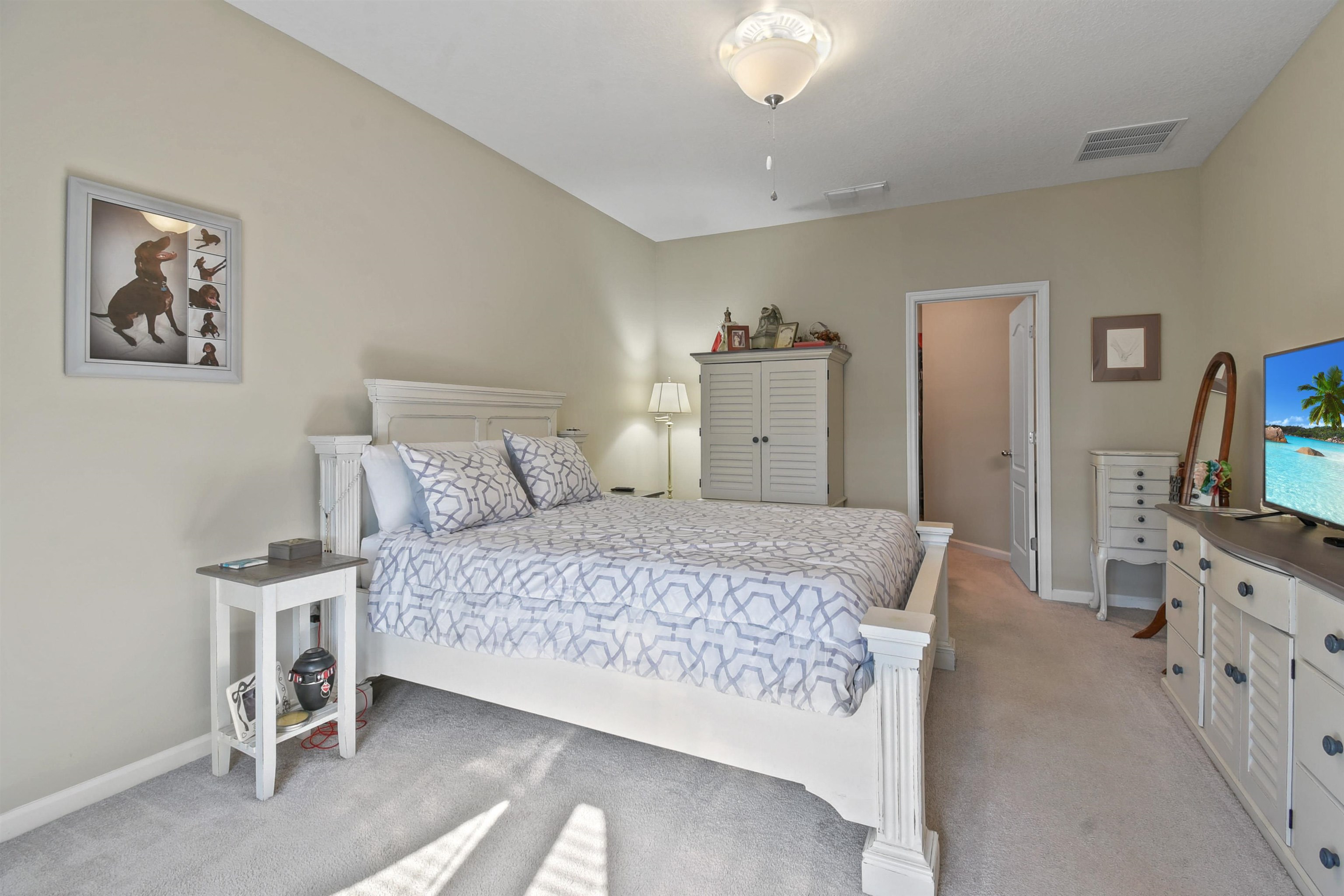 53 Cloverly Point St. Augustine, FL 32092 - Photo 19 of 51 a bedroom with a bed and a flat tv screen on dresser
