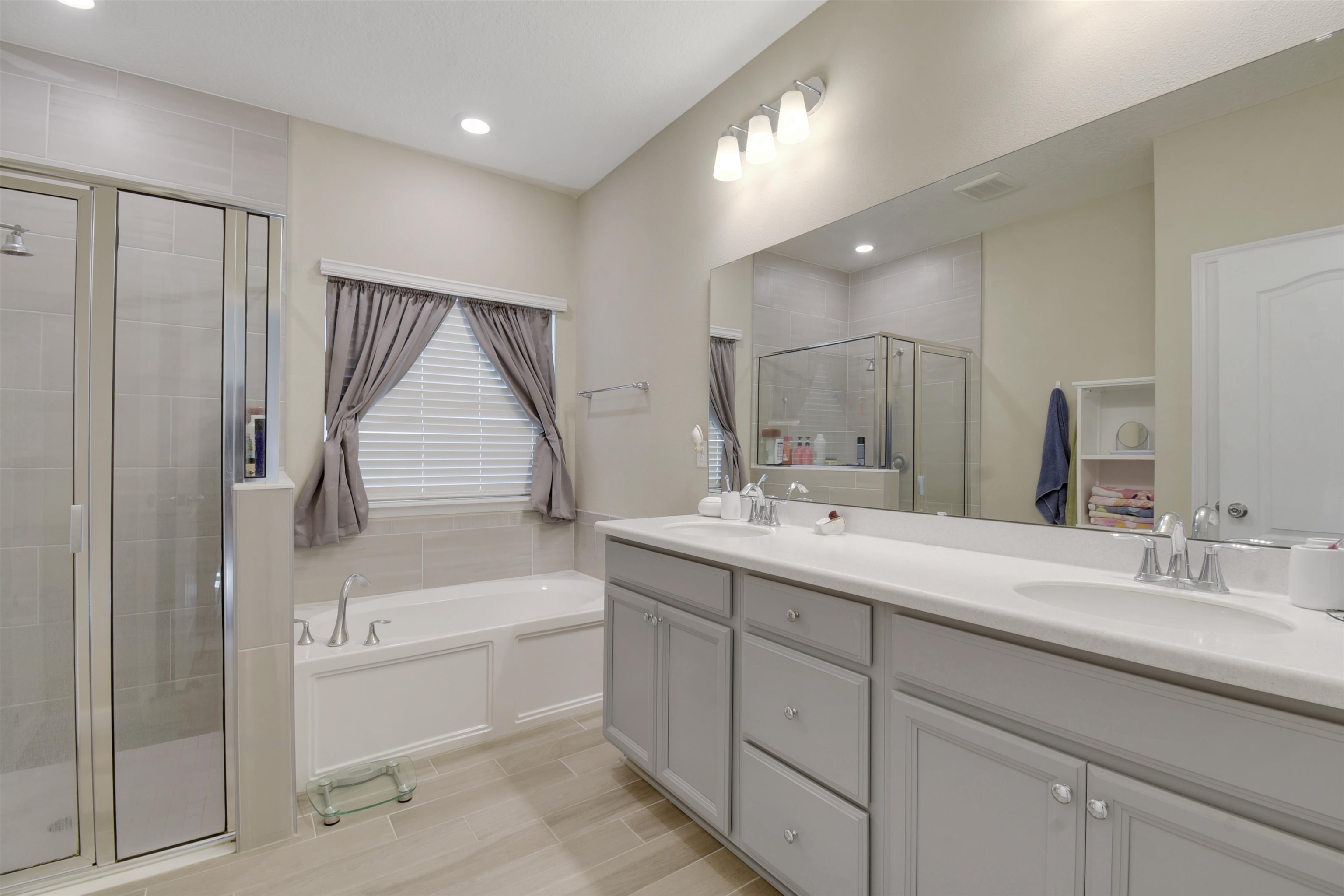53 Cloverly Point St. Augustine, FL 32092 - Photo 22 of 51 a bathroom with a double vanity sink a mirror and a bathtub