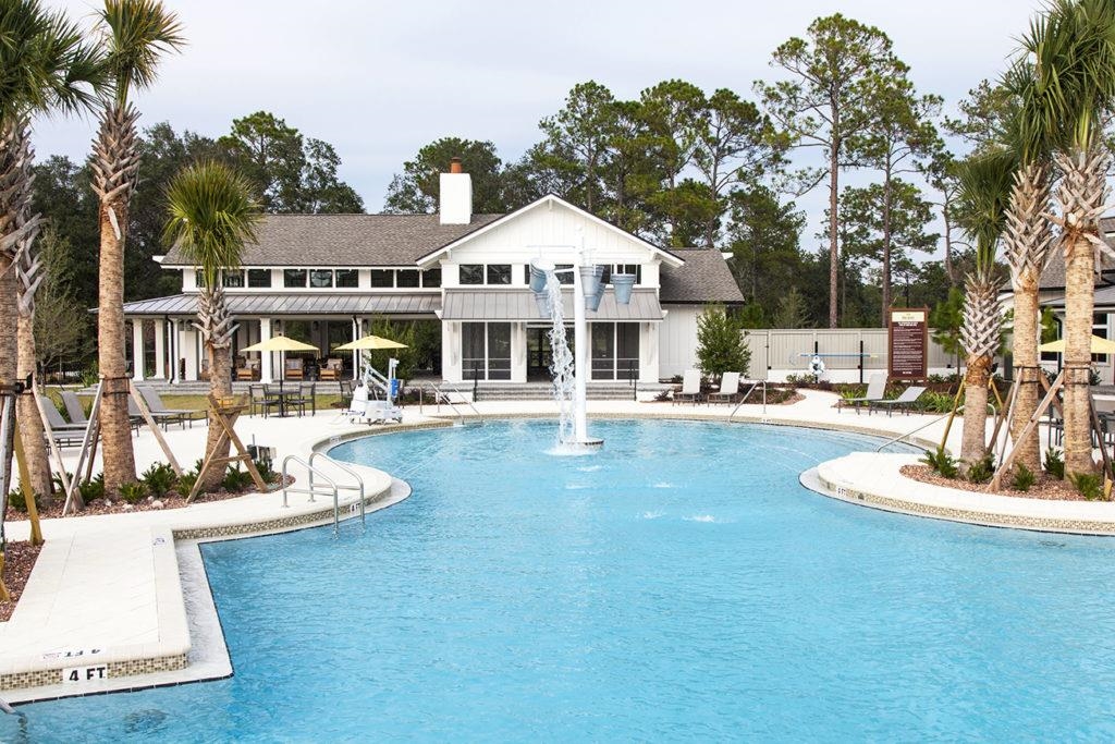 53 Cloverly Point St. Augustine, FL 32092 - Photo 40 of 51 a front view of a house with a garden and swimming pool