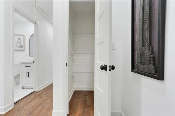 a view of a hallway with wooden floor and staircase