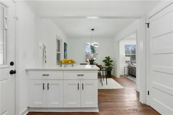 a view of living room with furniture and wooden floor