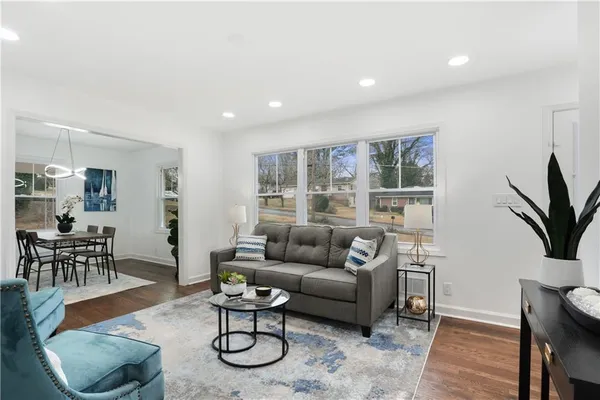 a living room with furniture potted plant and a table