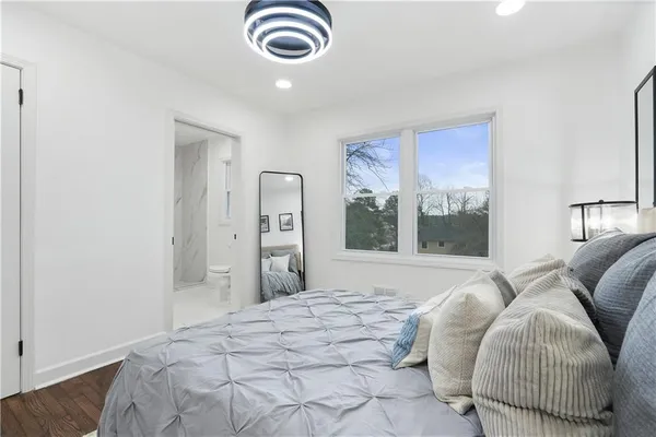 a bedroom with a bed and a large window