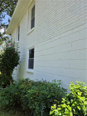 a front view of a house with plants