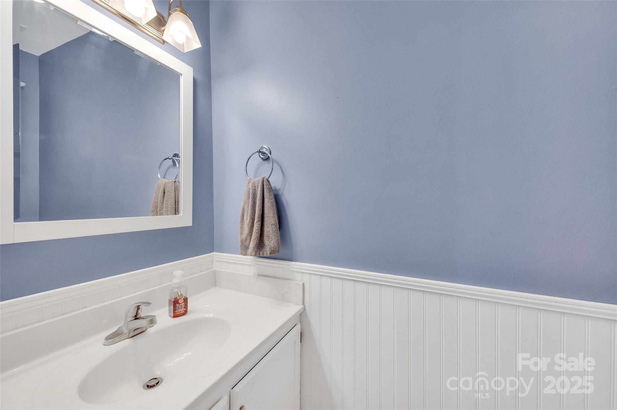 12351 Cardinal Point Road Charlotte, NC 28269 - Photo 16 of 43 a bathroom with a sink and a mirror