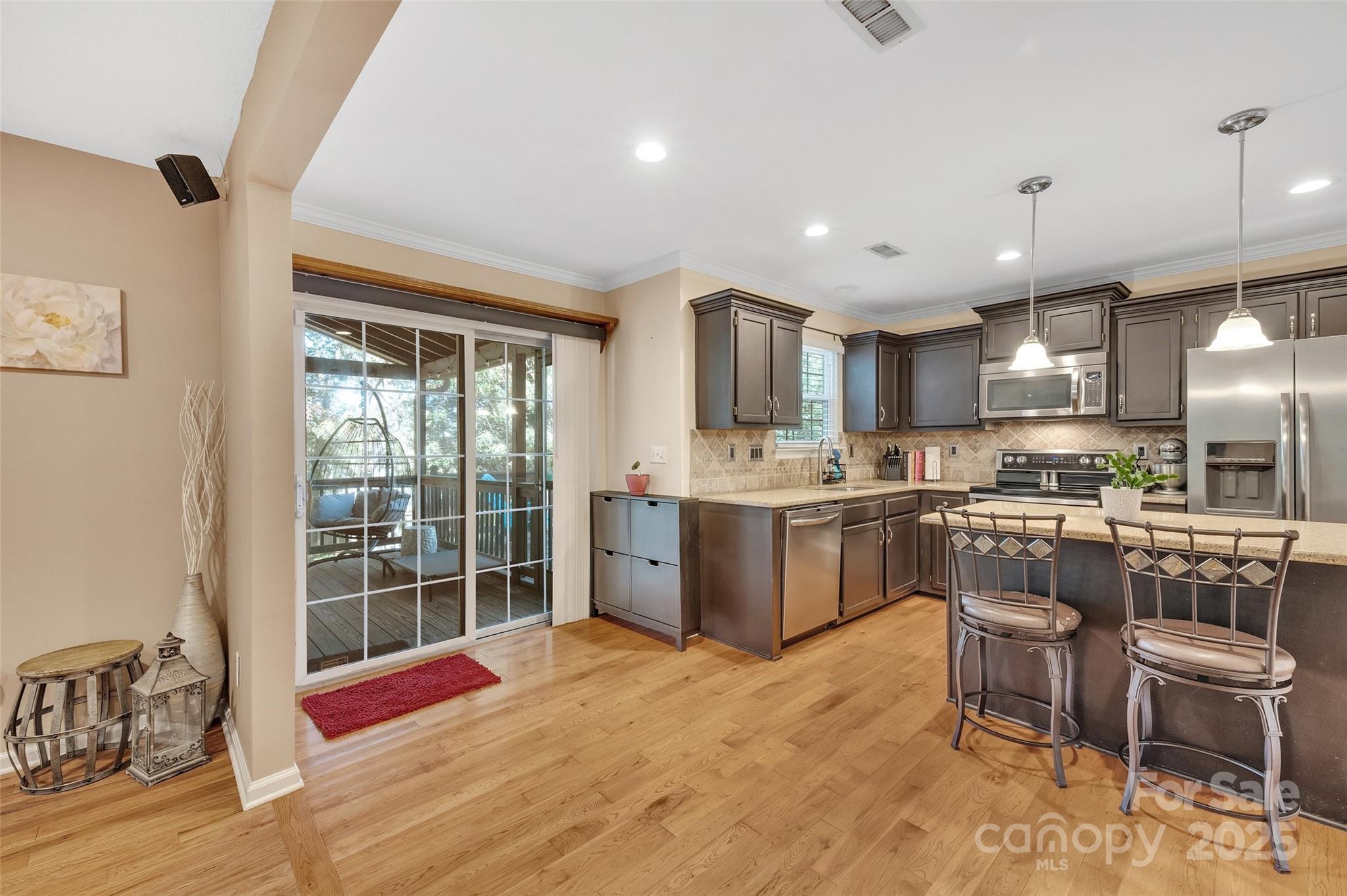 12351 Cardinal Point Road Charlotte, NC 28269 - Photo 17 of 43 a kitchen with a sink cabinets and wooden floor