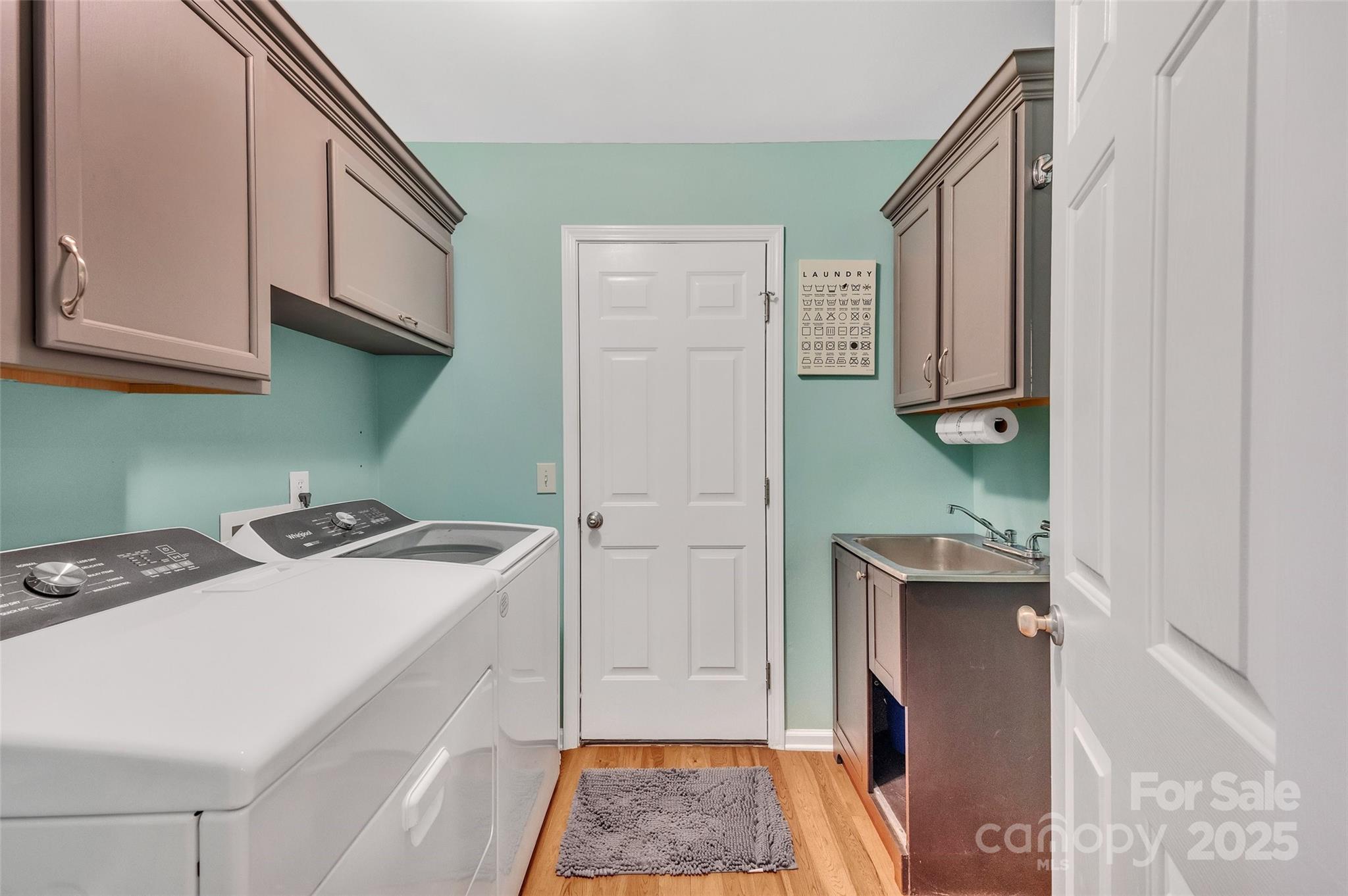 12351 Cardinal Point Road Charlotte, NC 28269 - Photo 19 of 43 a room with cabinets and washer