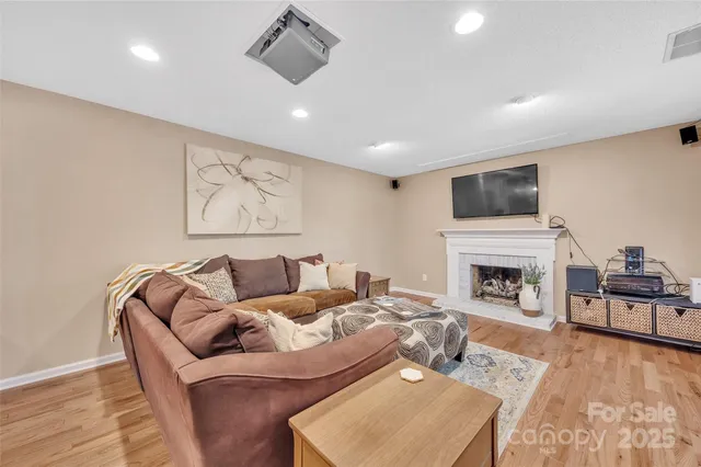 a living room with furniture a fireplace and a flat screen tv