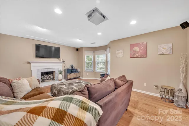 a living room with furniture fireplace and a flat screen tv