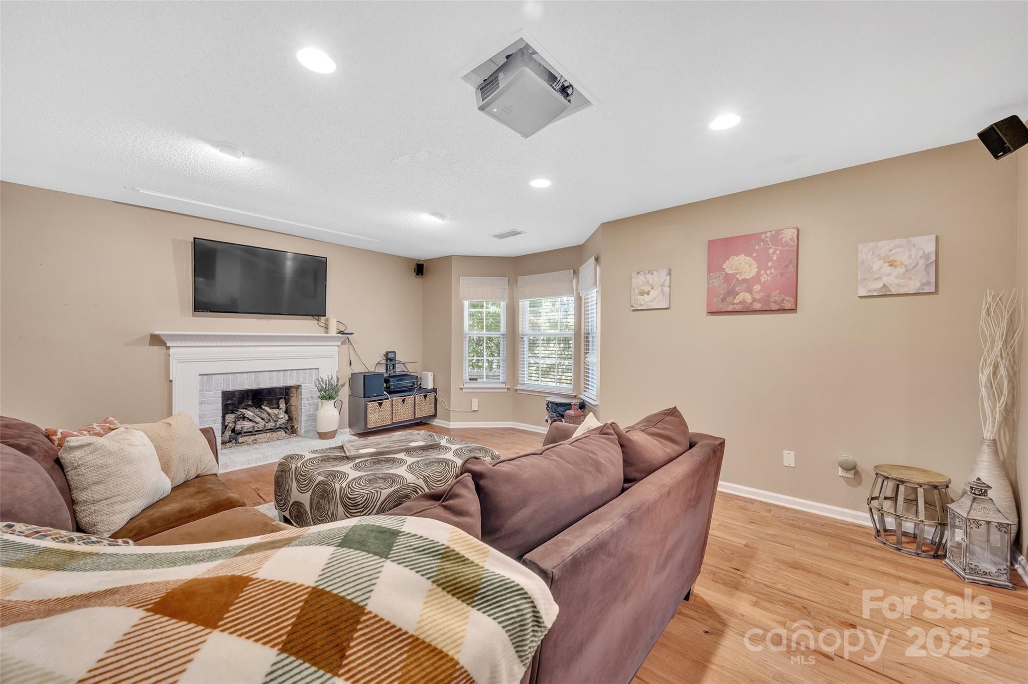 12351 Cardinal Point Road Charlotte, NC 28269 - Photo 21 of 43 a living room with furniture a fireplace and a flat screen tv