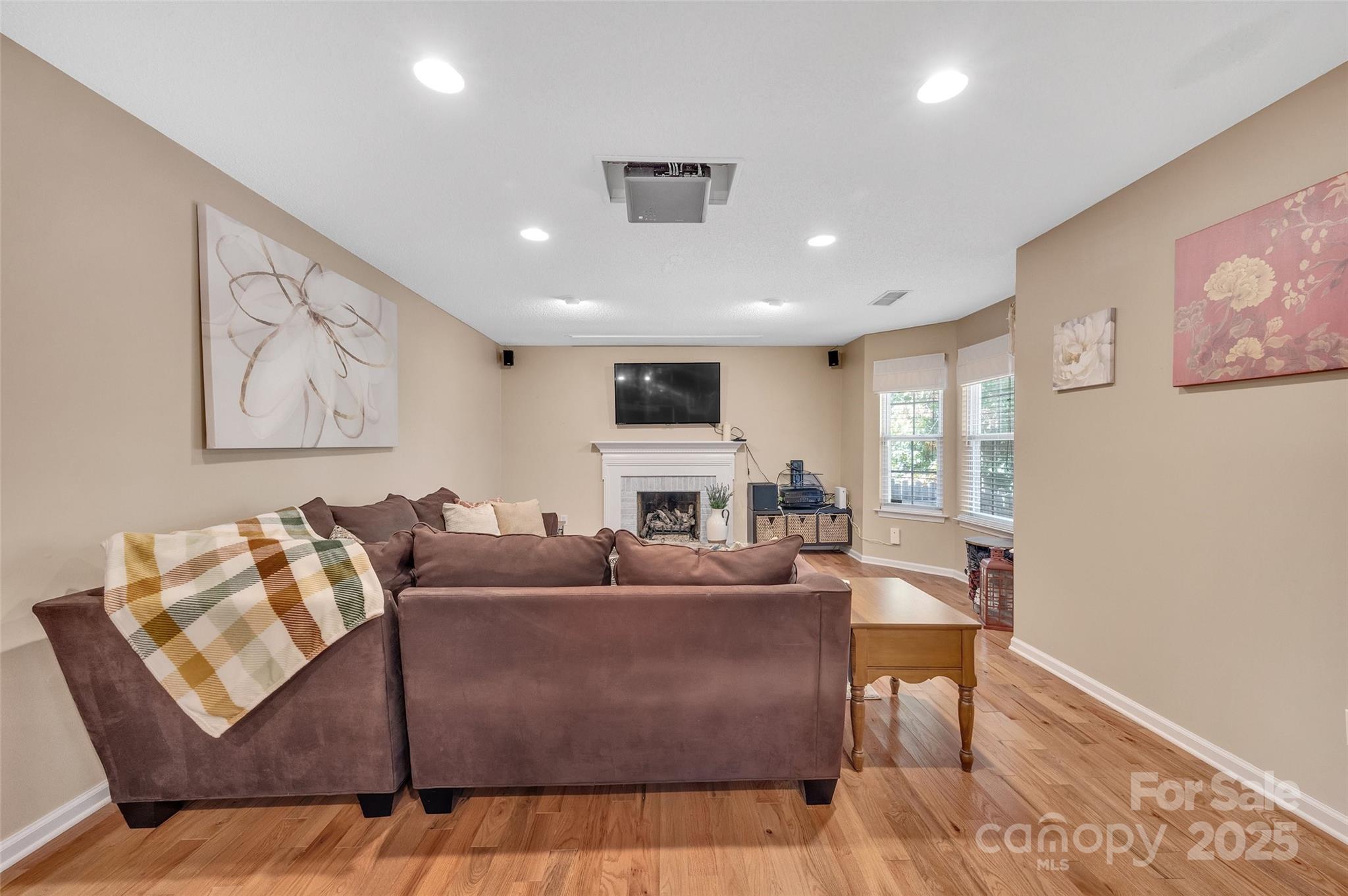 12351 Cardinal Point Road Charlotte, NC 28269 - Photo 22 of 43 a living room with furniture fireplace and a flat screen tv