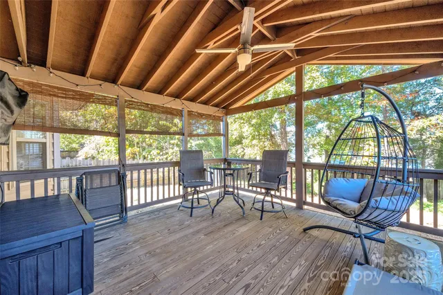 a view of a deck with wooden floor and outdoor seating