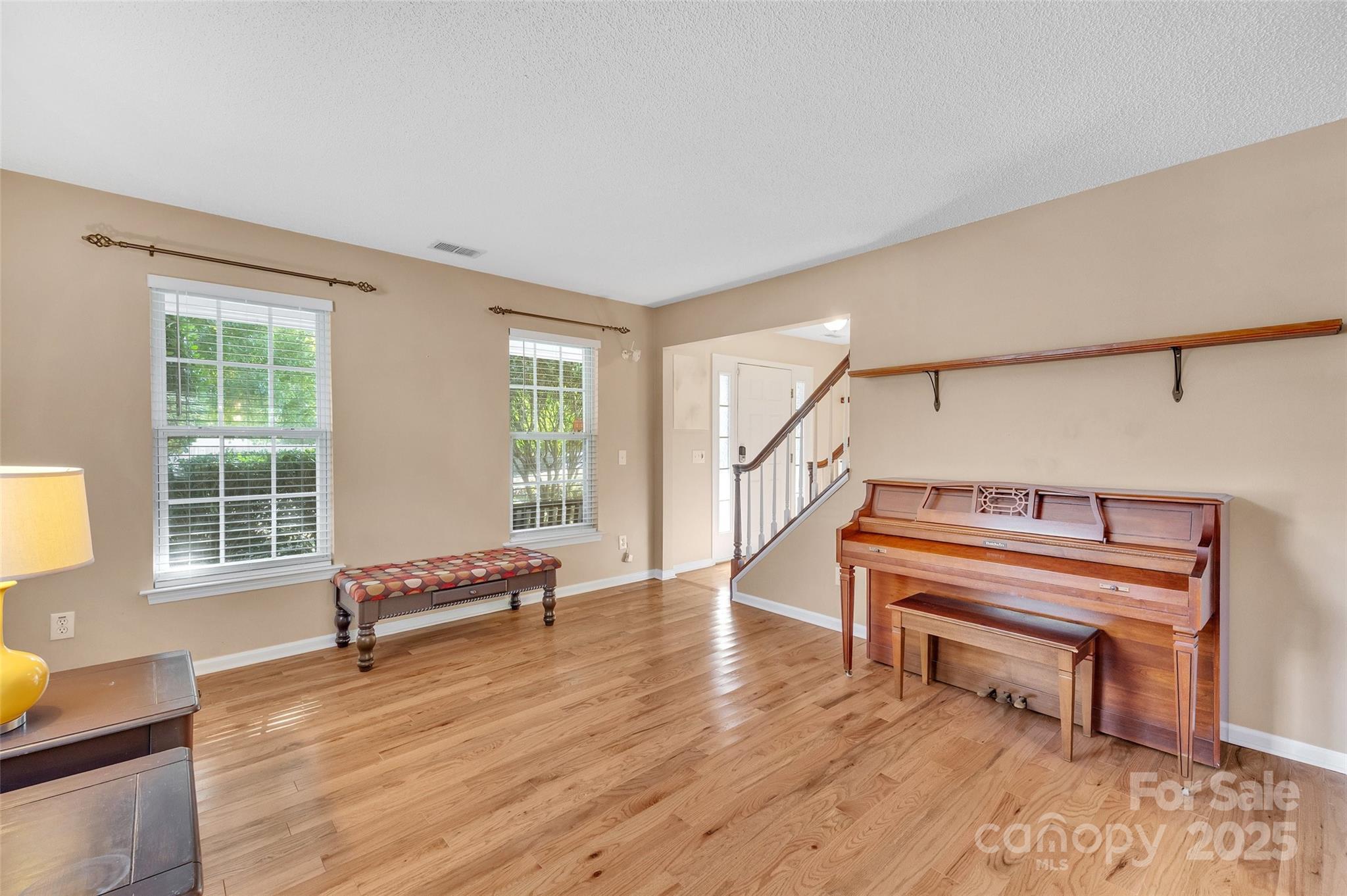 12351 Cardinal Point Road Charlotte, NC 28269 - Photo 9 of 43 a living room with furniture a piano and wooden floor