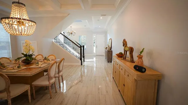 a living room with furniture wooden floor and a large window
