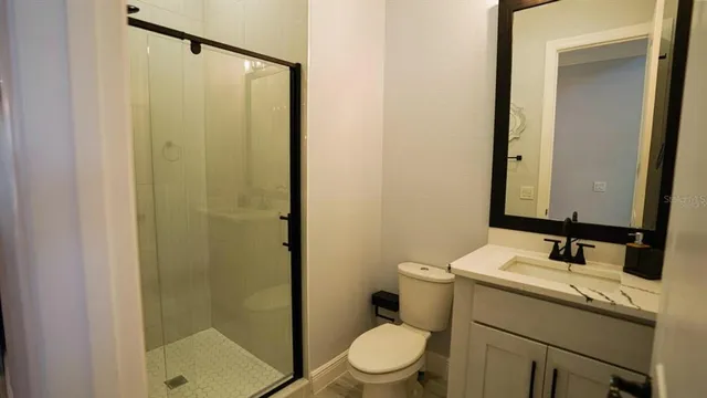 a living room with furniture a wooden floor and a flat screen tv