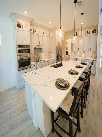 a living room with furniture wooden floor and a large window