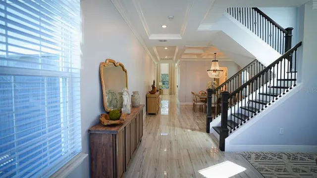 a view of entryway and hall with wooden floor